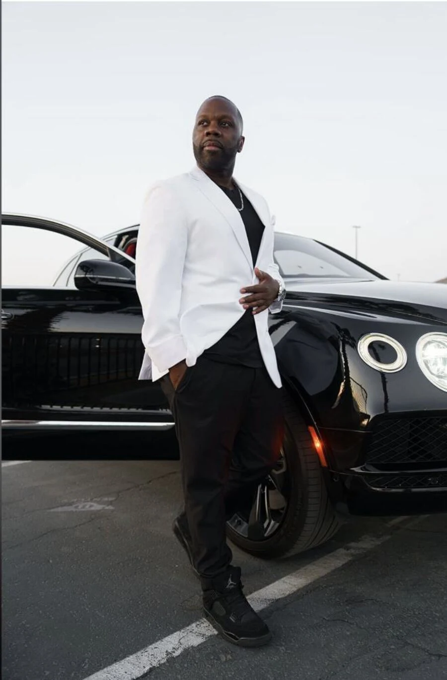 Antoine Sallis standing beside a black luxury car